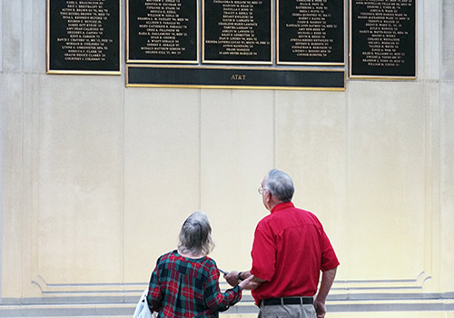 Lifetime members lookin at alumni wall.