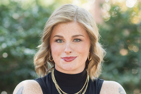 Alexis Rockwell standing with arms crossed