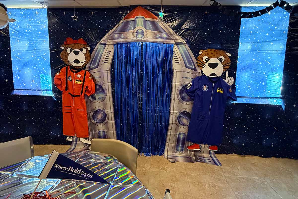 Room decorated for Homecoming with Southpaw and Ms Pawla dressed as astronauts with spaceship in between them. Room decorated for Homecoming with Southpaw and Ms Pawla dressed as astronauts with spaceship in between them.